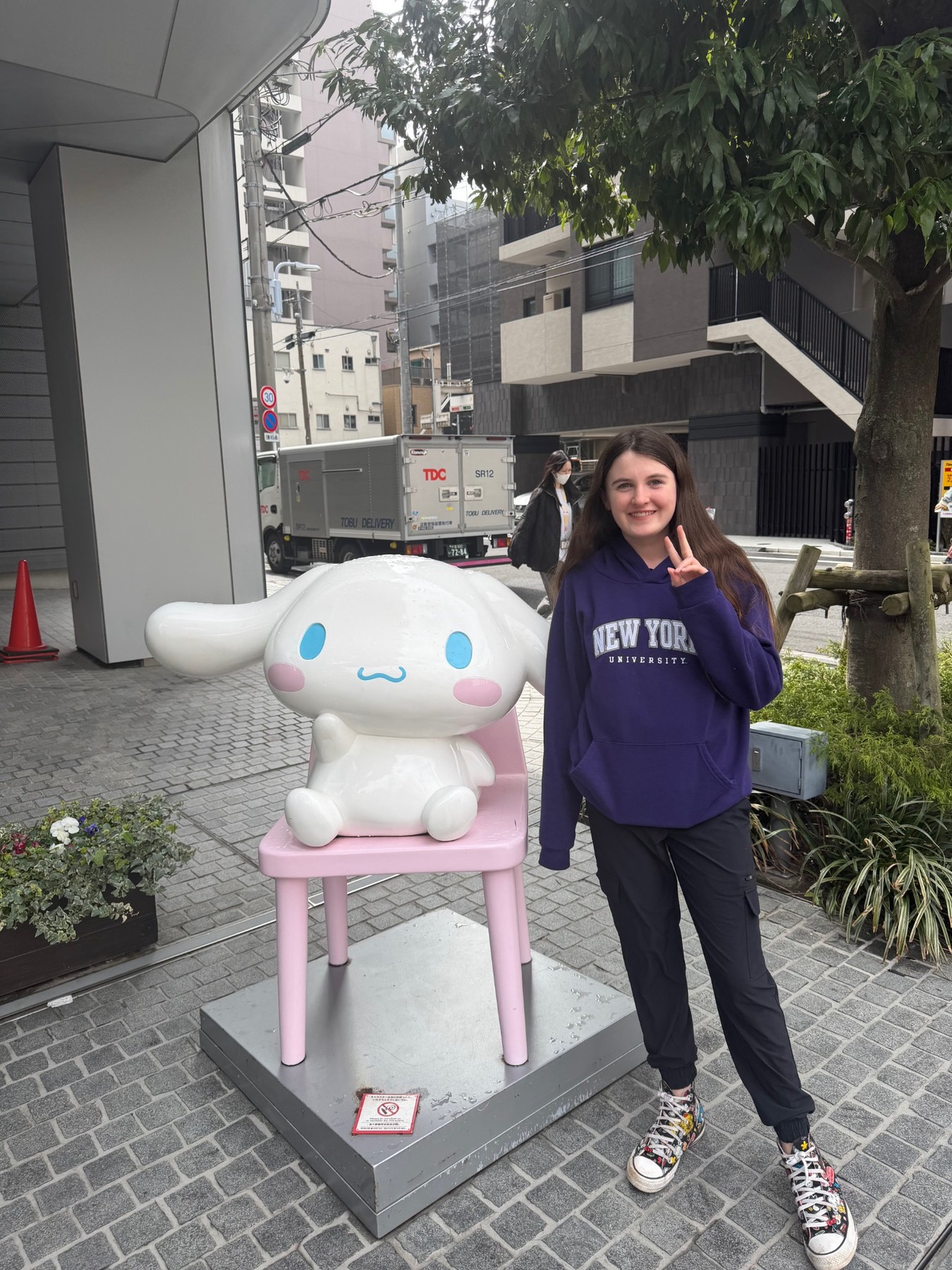 Young performer wearing a purple New York University hoodie